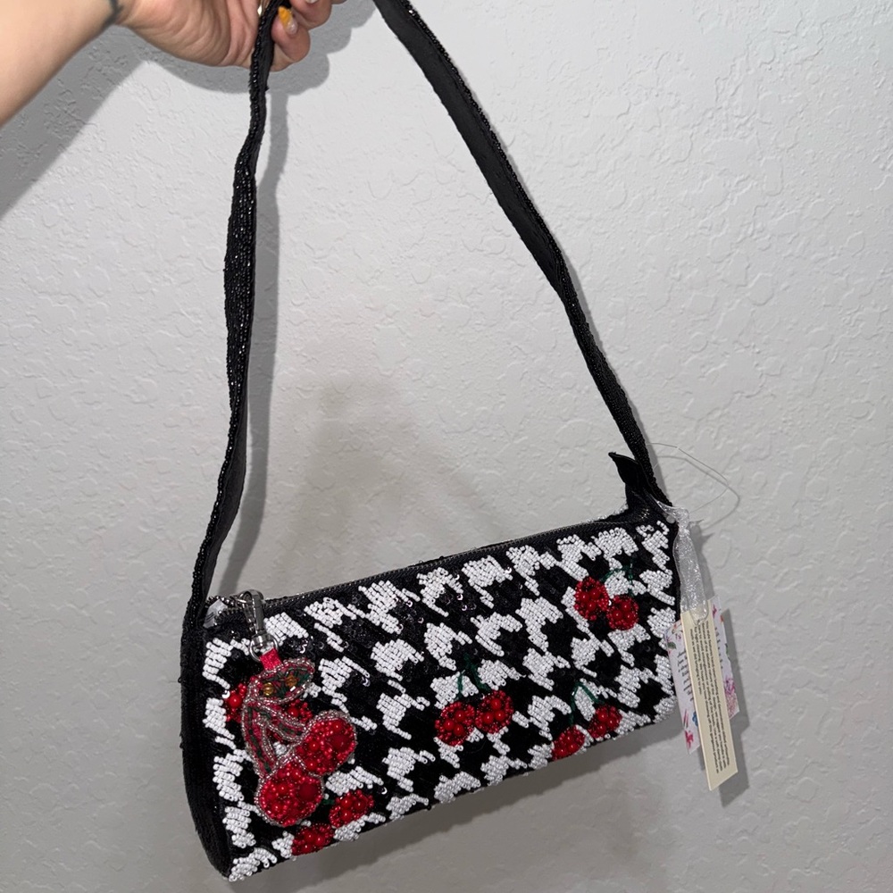 Elegant Black and White Patterned Shoulder Bag with Red Details
